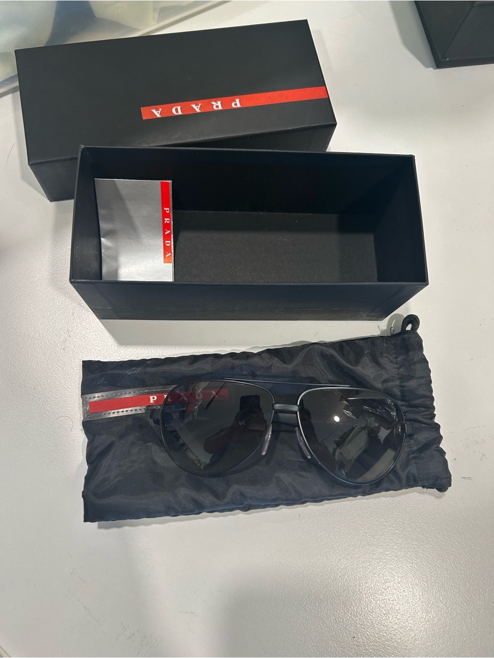 Prada Men’s Black Aviator Sunglasses with Red Stripe